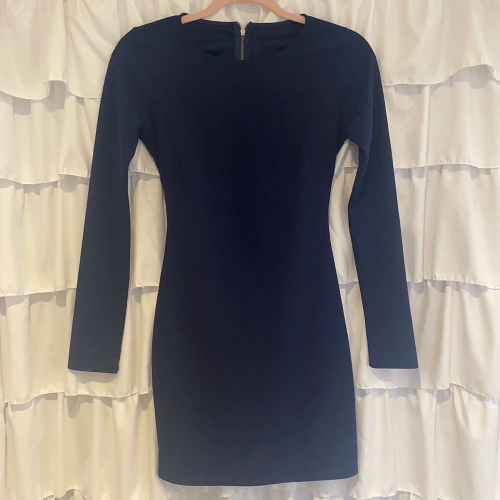 Navy blue long sleeve dress with open back.